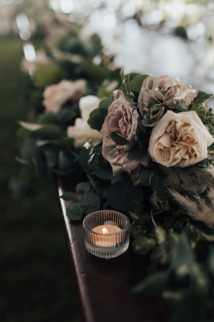 Pale roses and greenery with tea light candles for rustic wedding styled by Joy By Joelle.