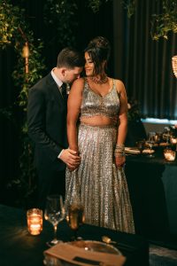 Amol and David Wedding-Joy By Joelle Bride in silver dress with groom in black tux in a moody wedding design by Joy By Joelle.