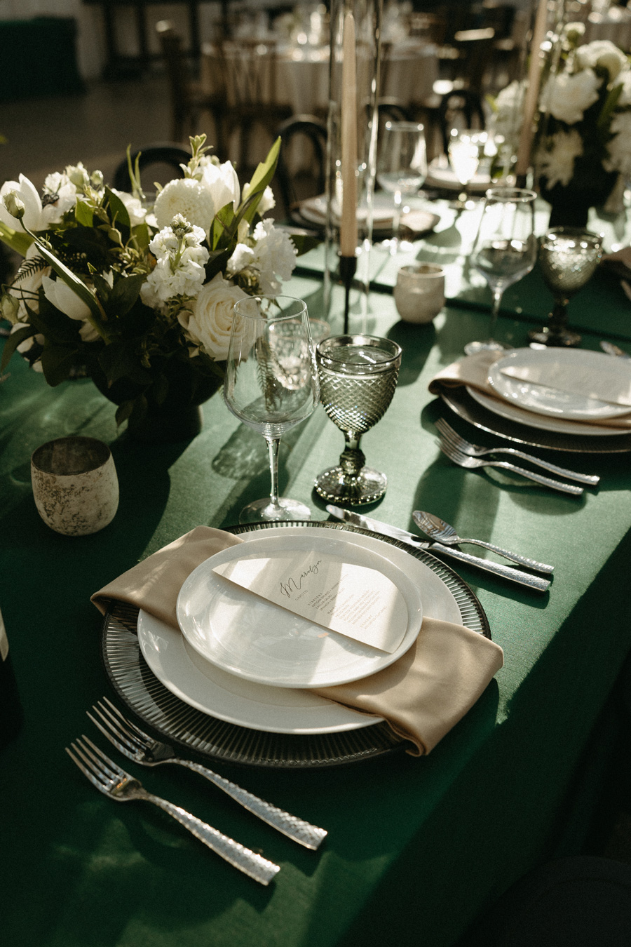Green tablescape with white florals and tapered candles designed by Joy By Joelle.