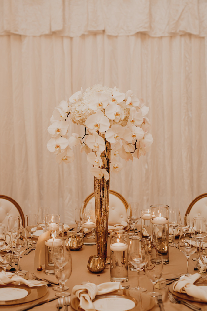 White luxury tented wedding with white florals and gold table setting styled by Joy By Joelle.
